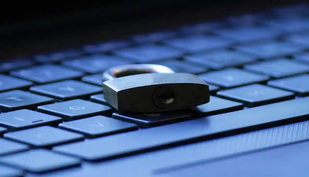 A padlock sits on a computer keyboard
