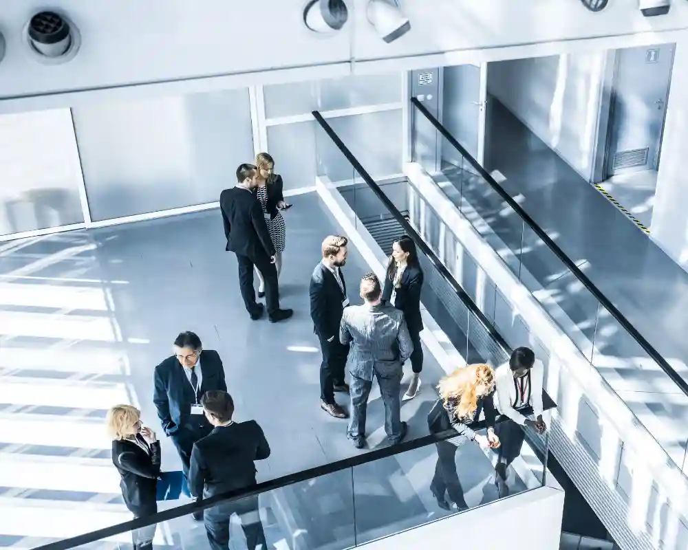 Professionals standing in groups talking