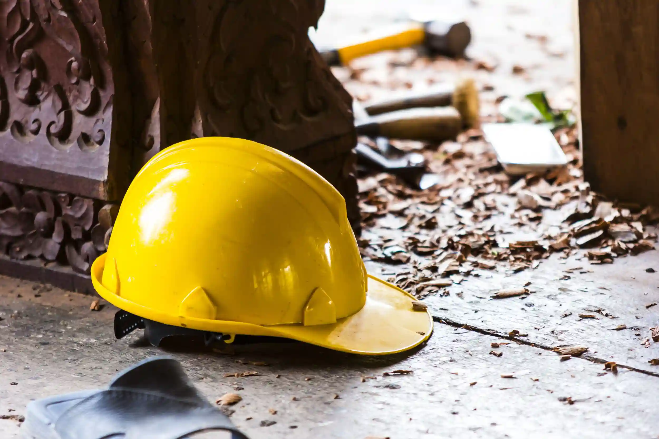 Hard hat on the construction site on the background.