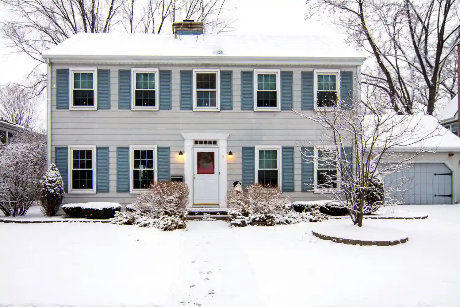 Large, two-story house with snow on the ground.