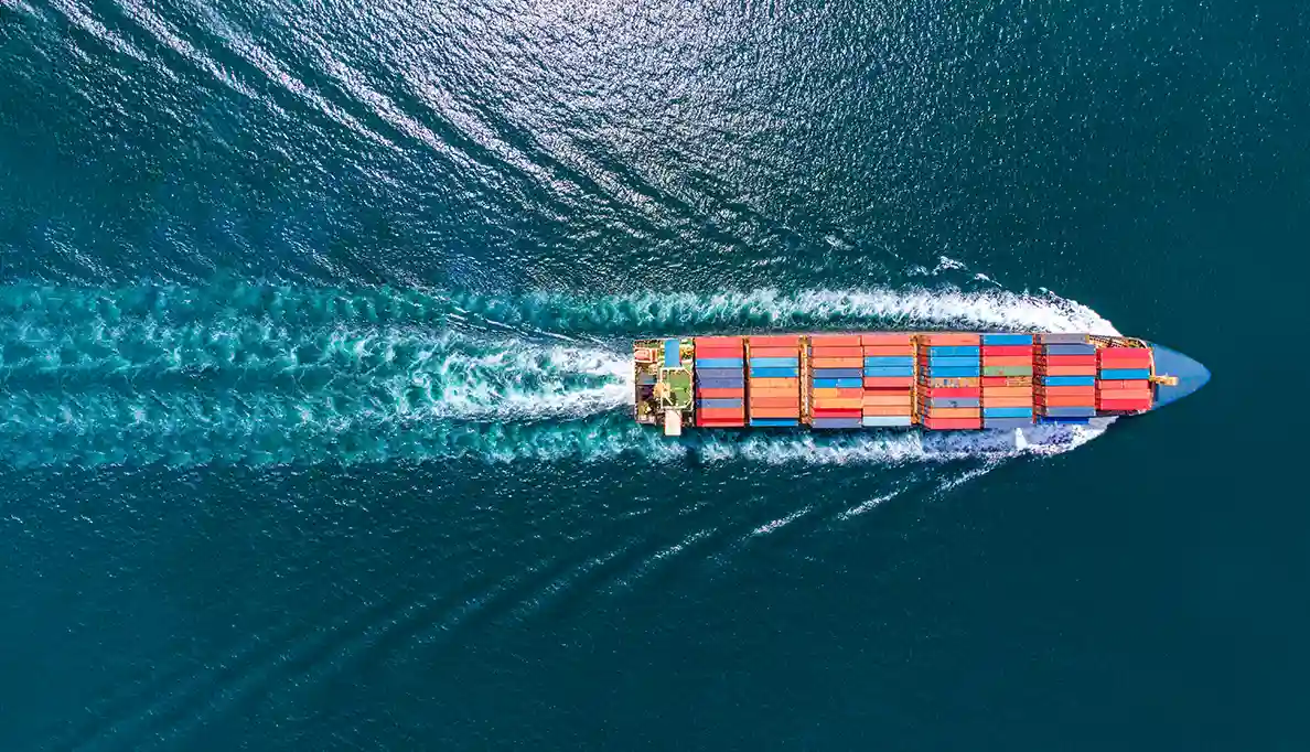 A bird's eye view of a container ship at sea
