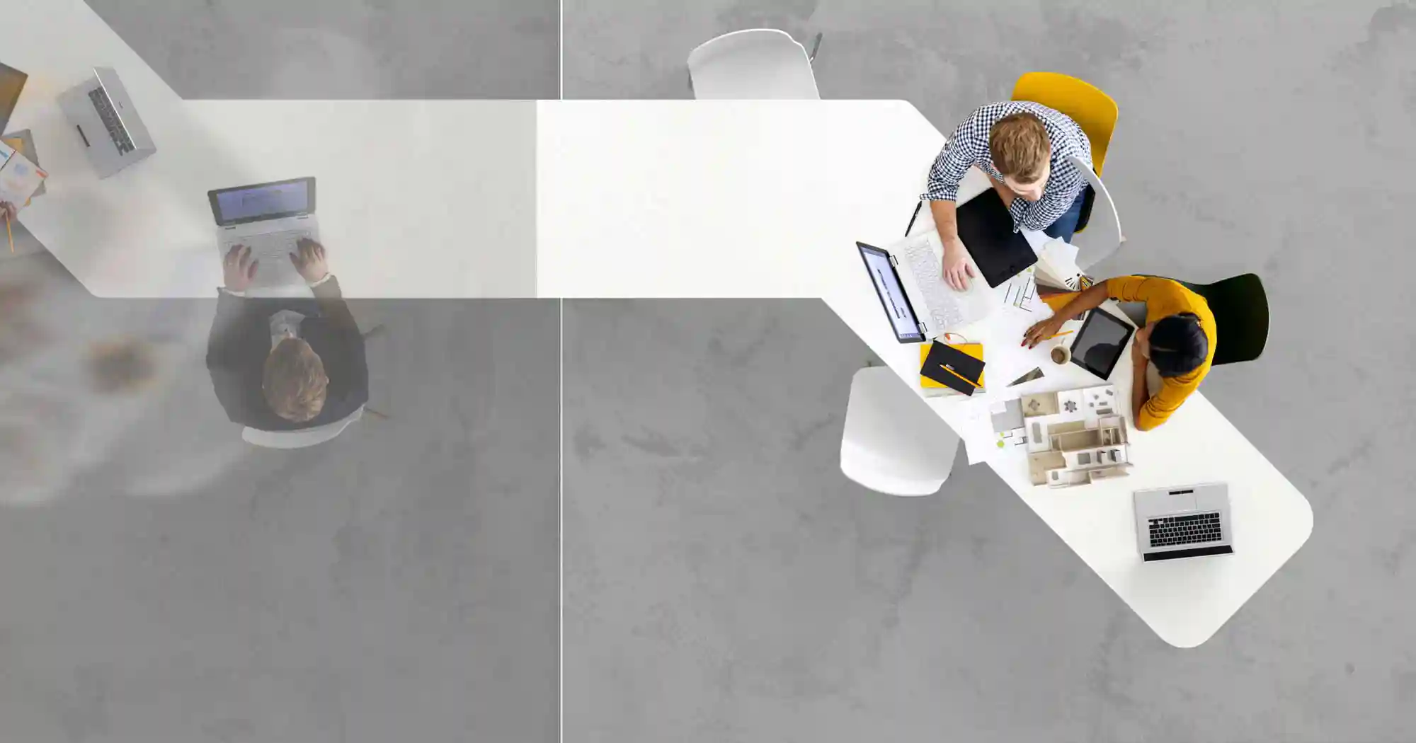 View from above of people working on computers at a desk